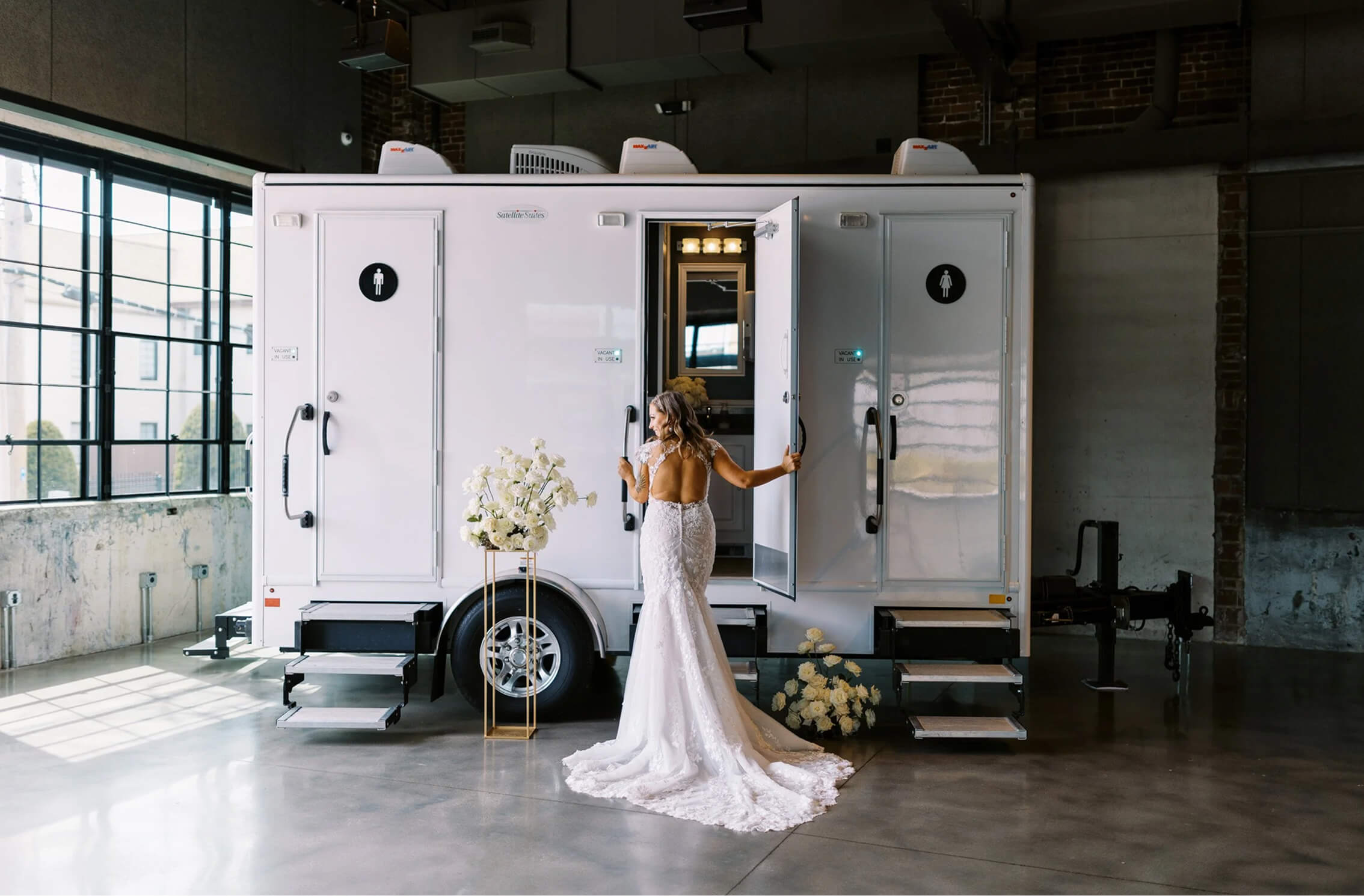 New bride entering luxury restroom trailer at wedding reception