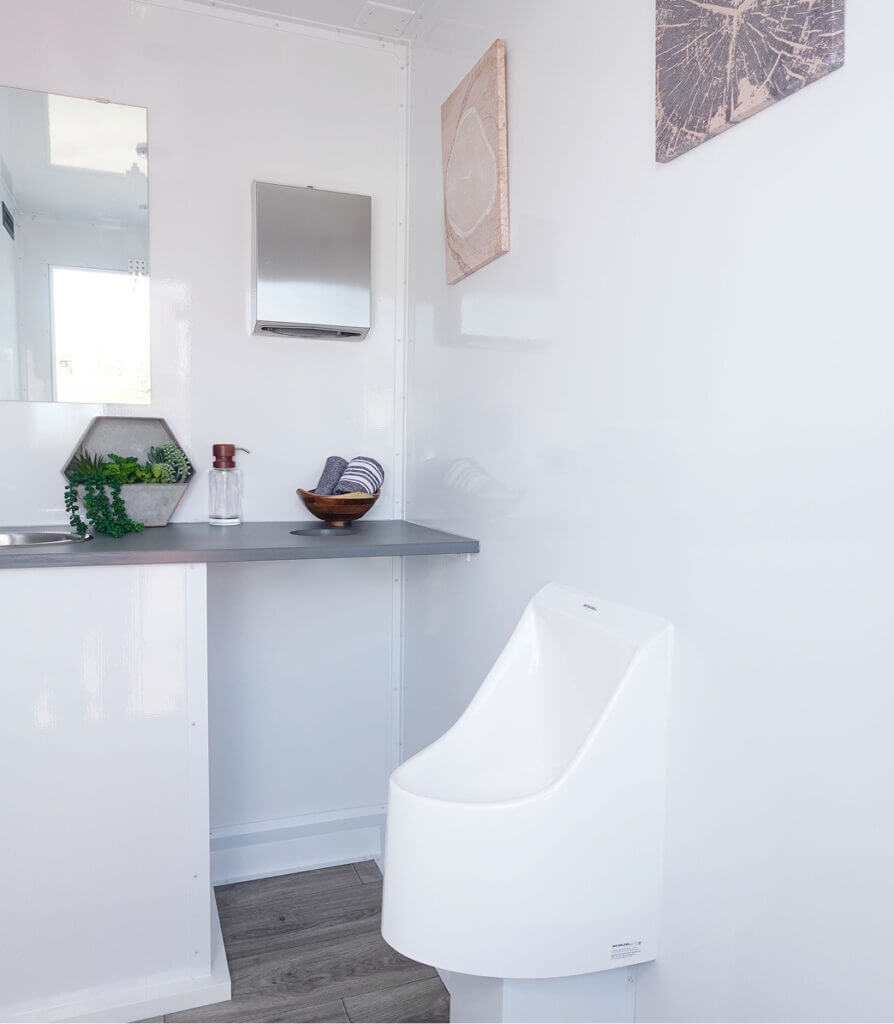 Interior view of a luxury trailer stall with white toilet