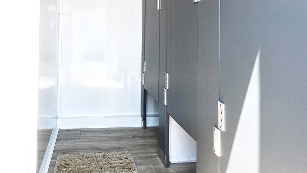 three restroom stalls with gray doors