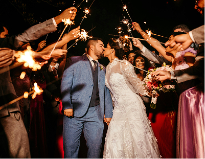 Bride and groom kissing as they leave a reception with a sparkler send off